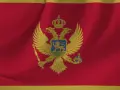 Flaga Czarnogóry z dwugłowym orłem. W tym kraju obowiązuje euro, a język urzędowy to czarnogórski.