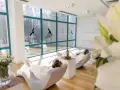 Relaks w spa, idealne ciechocinek atrakcje na weekend. Dwie kobiety w szlafrokach odpoczywają w fotelach, słuchając muzyki.