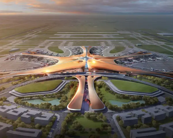 Futurystyczny terminal lotniska, przypominający rozgwiazdę, z samolotami na płycie. To największe lotnisko na świecie, z nowoczesną architekturą i otaczającą zielenią.