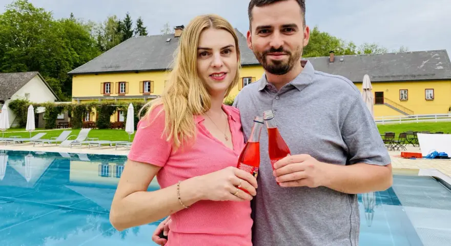 Para z napojami przy basenie. Taki nocleg tranzytowy to idealny przystanek w podróży.