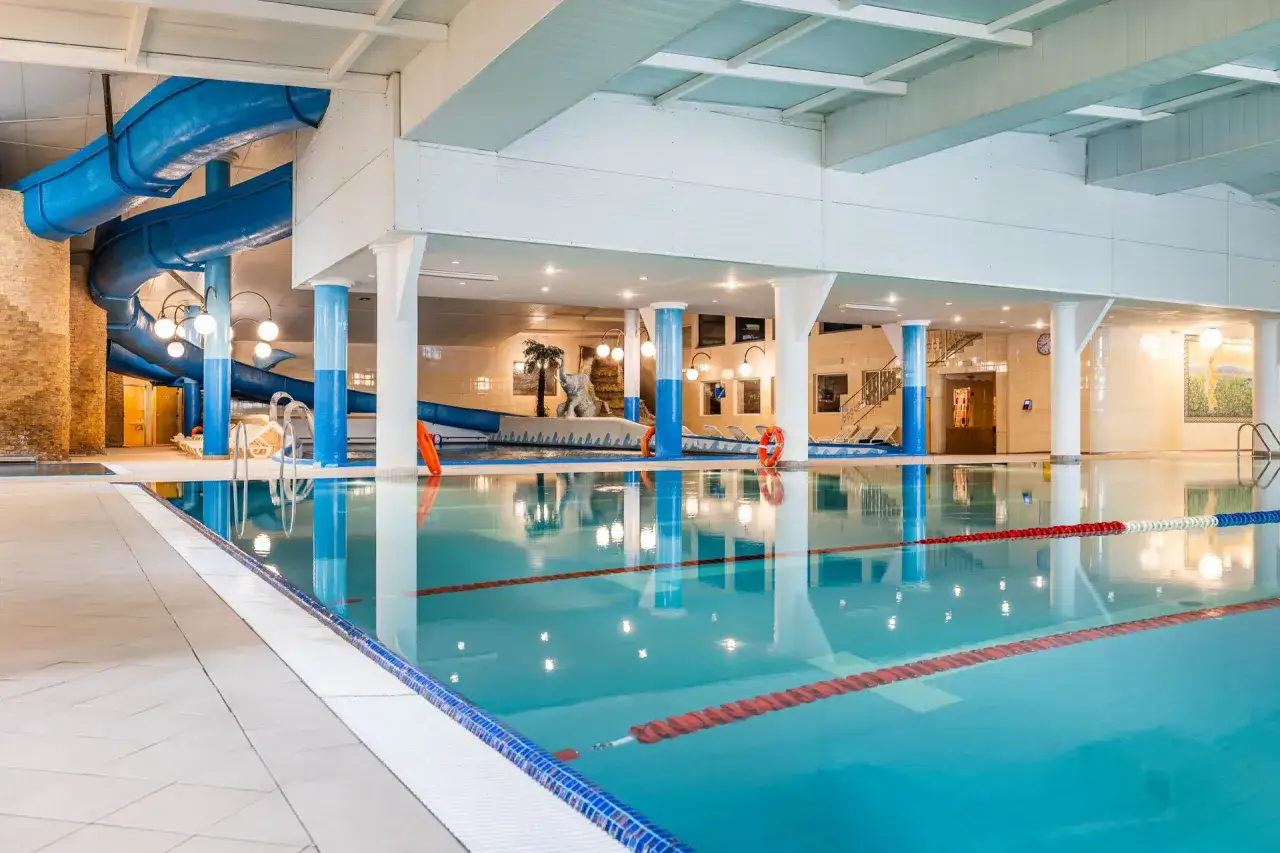 Basen z niebieską zjeżdżalnią w Hotelu Gołębiewski Białystok. Sprawdź hotel gołębiewski białystok ceny i zaplanuj rodzinny wypoczynek.